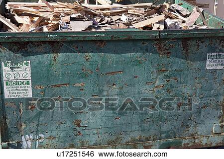 Stock Photograph - Overflowing dumpster with scrap wood. Fotosearch