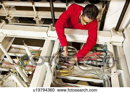 Overhead view of technician repairing water pump on a piece of industrial equipment View Large Photo Image Stock Image - Overhead view of technician repairing water pump on a piece of industrial equipment . Fotosearch