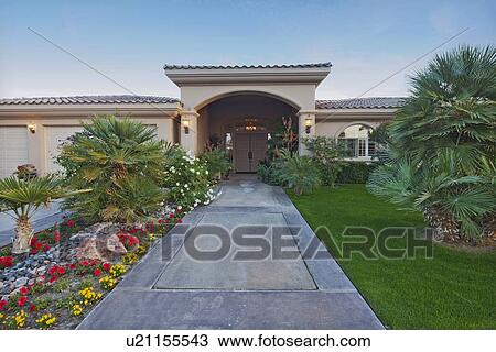 Stock Image - Path leading up to luxury bungalow. Fotosearch