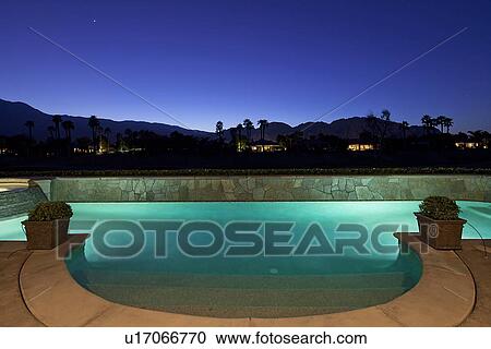Pool lit from underneath at dusk View Large Photo Image Stock Image - Pool lit from underneath at dusk. Fotosearch