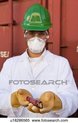 Stock Photography - Safety inspector holding explosive material. Fotosearch