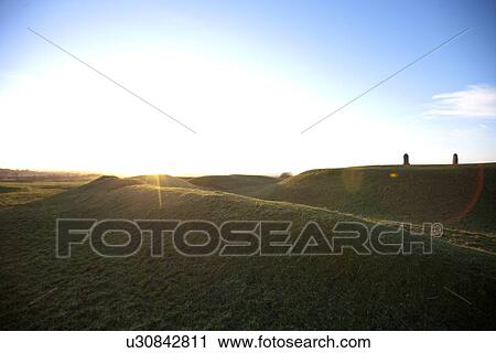 Stock Image - Sun flare over Hill of Tara, Ireland. Fotosearch