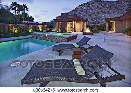 Stock Photograph - Sun lounges by the pool. Fotosearch