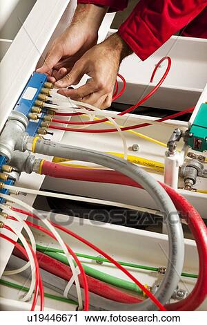Technician fixing cabling and wiring circuit View Large Photo Image Stock Image - Technician fixing cabling and wiring circuit. Fotosearch