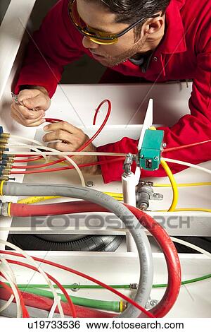 Technician inspecting colorful wiring circuit View Large Photo Image Stock Photograph - Technician inspecting colorful wiring circuit. Fotosearch