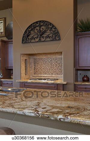 Stock Photograph - View over counter to stove in traditional kitchen. Fotosearch