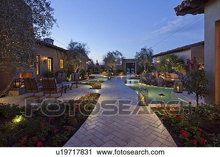 Stock Image - View through garden pond to entry gate. Fotosearch