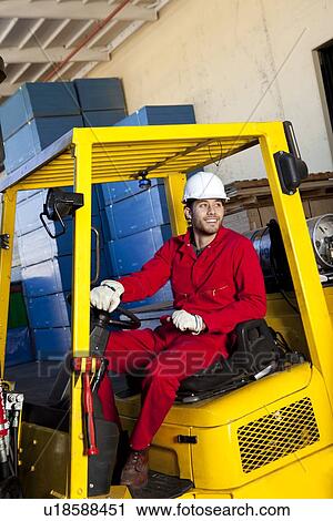 Warehouse worker using forklift truck View Large Photo Image Stock Image - Warehouse worker using forklift truck. Fotosearch