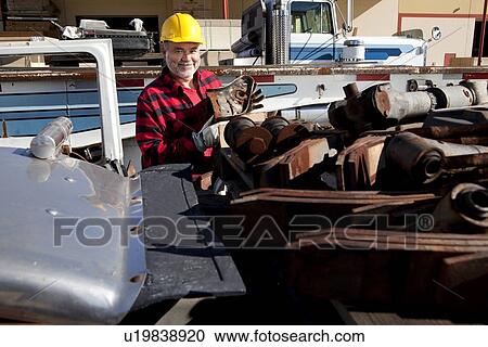 Worker sorting scrap metal in front of Cargo truck View Large Photo Image Stock Image - Worker sorting scrap metal in front of Cargo truck. Fotosearch