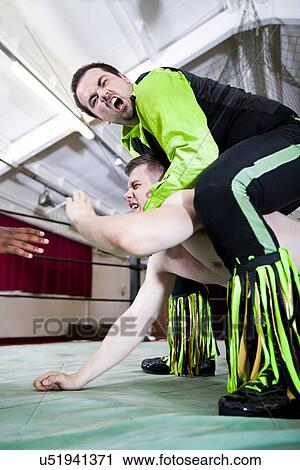 Aggression wrestler giving headlock to rival during match View Large Photo Image Stock Image - Aggression wrestler giving headlock to rival during match. Fotosearch