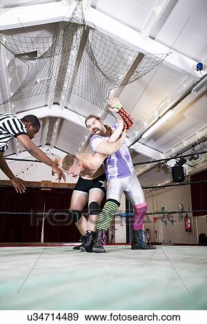 Aggressive wrestler fighting with rival in ring View Large Photo Image Stock Photo - Aggressive wrestler fighting with rival in ring. Fotosearch