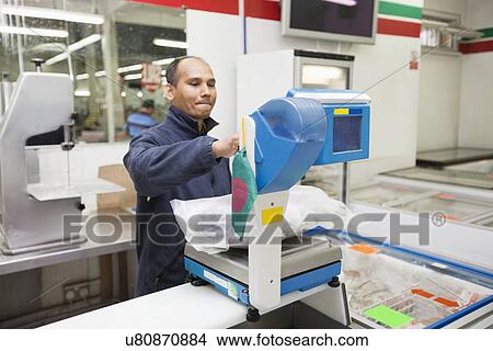 Employee weighing product in supermarket View Large Photo Image Picture - Employee weighing product in supermarket. Fotosearch