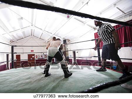 Full-length of wrestlers fighting in ring View Large Photo Image Stock Image - Full-length of wrestlers fighting in ring. Fotosearch
