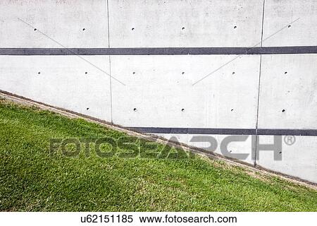 Green grass slope next to brick wall View Large Photo Image Stock Photography - Green grass slope next to brick wall. Fotosearch