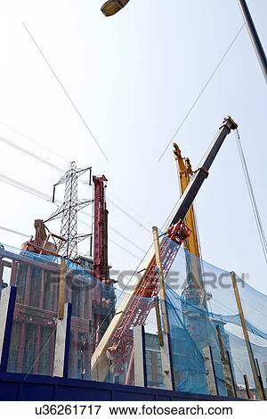 Heavy machinery digging foundations on building site View Large Photo Image Stock Photo - Heavy machinery digging foundations on building site. Fotosearch