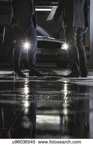 Low section of businessmen conducting suspicious business in basement View Large Photo Image Stock Photography - Low section of businessmen conducting suspicious business in basement. Fotosearch