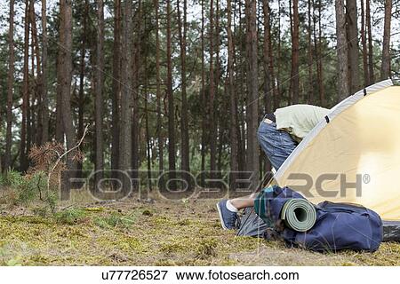 Low section of man entering tent in forest View Large Photo Image Stock Photo - Low section of man entering tent in forest. Fotosearch