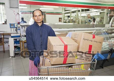 Portrait of male worker with shopping cart View Large Photo Image Picture - Portrait of male worker with shopping cart. Fotosearch
