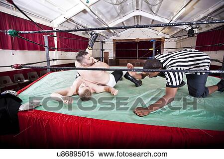 Referee counting knockout while wrestlers wrestling in ring View Large Photo Image Stock Photography - Referee counting knockout while wrestlers wrestling in ring. Fotosearch