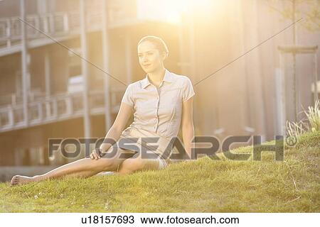 Relaxed young businesswoman sitting on office lawn View Large Photo Image Stock Image - Relaxed young businesswoman sitting on office lawn. Fotosearch