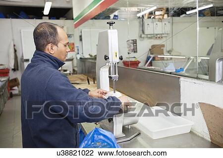 Side view of male employee working in supermarket View Large Photo Image Stock Image - Side view of male employee working in supermarket. Fotosearch