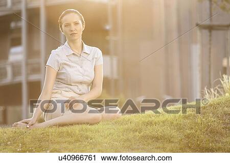 Thoughtful young businesswoman sitting on office lawn View Large Photo Image Stock Image - Thoughtful young businesswoman sitting on office lawn. Fotosearch