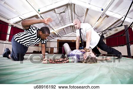 Wrestler pinning rival while referee counting down during match View Large Photo Image Stock Image - Wrestler pinning rival while referee counting down during match. Fotosearch