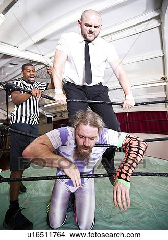 Wrestlers fighting while referee counting during match View Large Photo Image Picture - Wrestlers fighting while referee counting during match. Fotosearch