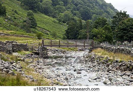 Bridge with slow flowing river in countryside View Large Photo Image Stock Image - Bridge with slow flowing river in countryside. Fotosearch
