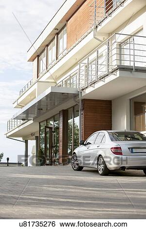 Stock Photograph - Car parked outside hotel. Fotosearch