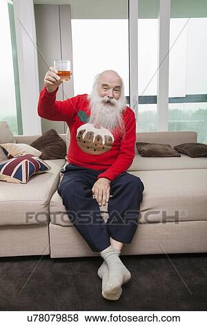 Full length portrait of senior man holding beer glass in living room View Large Photo Image Stock Photo - Full length portrait of senior man holding beer glass in living room. Fotosearch