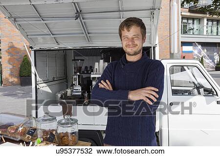 Portrait of young man with arms crossed standing against mobile coffee shop View Large Photo Image Stock Image - Portrait of young man with arms crossed standing against mobile coffee shop. Fotosearch