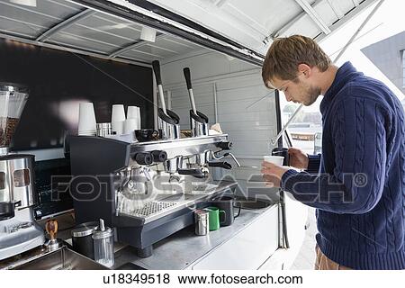 Profile shot of man pouring milk in cup at mobile coffee shop View Large Photo Image Stock Photo - Profile shot of man pouring milk in cup at mobile coffee shop. Fotosearch