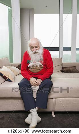 Sad pensive senior man sitting on sofa bed in living room View Large Photo Image Stock Image - Sad pensive senior man sitting on sofa bed in living room. Fotosearch