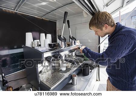 Side view of man working at mobile coffee shop View Large Photo Image Stock Photo - Side view of man working at mobile coffee shop. Fotosearch