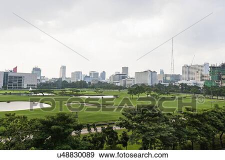 The 18 hole golf course at Royal Bangkok Sports Club in the middle of Bangkok City, Thailand View Large Photo Image Stock Photo - The 18 hole golf course at Royal Bangkok Sports Club in the middle of Bangkok City, Thailand. Fotosearch