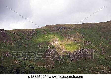 Stock Photography - View of grassy field against cloudy sky. Fotosearch