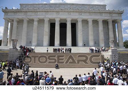 Stock Photo - Crowd watches the National Action to Realize the Dream march and rally commemorating the 50th Anniversary of the march on Washington, D. C.. Fotosearch
