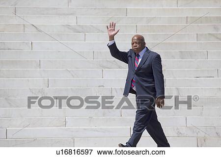 Stock Photo - Georgia Congressman John Lewis waves at the National Action to Realize the Dream march and rally commemorating the 50th Anniversary of the march on Washington, D. C.. Fotosearch