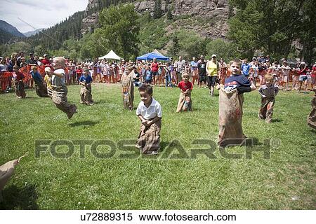 Stock Photography - July 4, Indpendence Day, kids compete in Three Legged race in Ouray, Colorado. Fotosearch