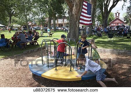 Stock Photography - Kids spin on playground in Town Park, Ridgway, Colorado. Fotosearch
