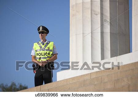 Stock Photograph - Policeman at the National Action to Realize the Dream march and rally commemorating the 50th Anniversary of the march on Washington, D. C.. Fotosearch