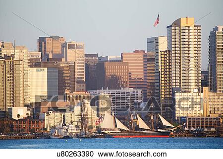 Stock Image - Scenic San Diego skyline, sailboat and waterfront, Pacific Ocean at sunset, California. Fotosearch