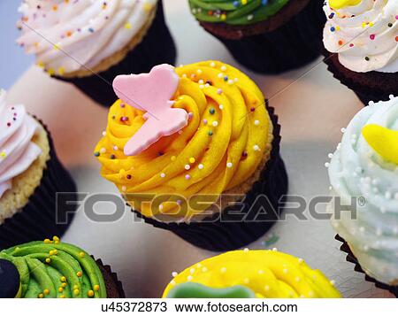 Stock Image - Birthday Cupcakes With Butterfly Decoration . Fotosearch