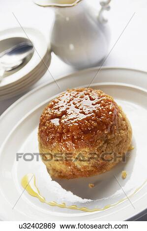 Stock Photo - Bowl Of Steamed Syrup Pudding With Jug Of Custard. Fotosearch