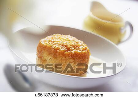 Stock Photo - Bowl Of Steamed Syrup Pudding With Jug Of Custard. Fotosearch