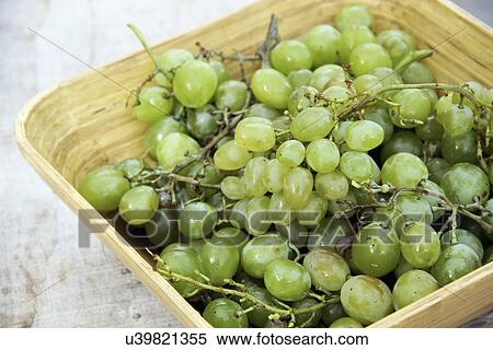Stock Photography - Bunch Of Green Grapes In Wooden Bowl. Fotosearch