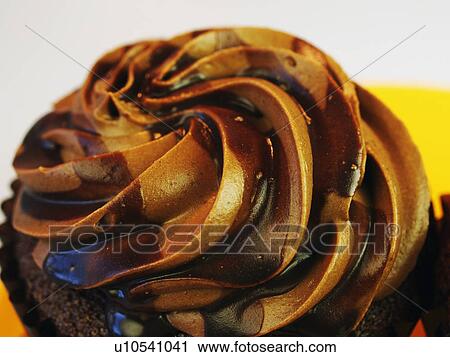 Stock Image - Close Up Of Single Chocolate Cupcake With Icing. Fotosearch