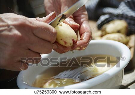 Man Peeling Potatoes Over Bowl Of Water View Large Photo Image Stock Image - Man Peeling Potatoes Over Bowl Of Water. Fotosearch