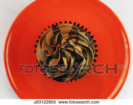 Stock Photography - Overhead Of Single Chocolate Cupcake With Icing. Fotosearch
